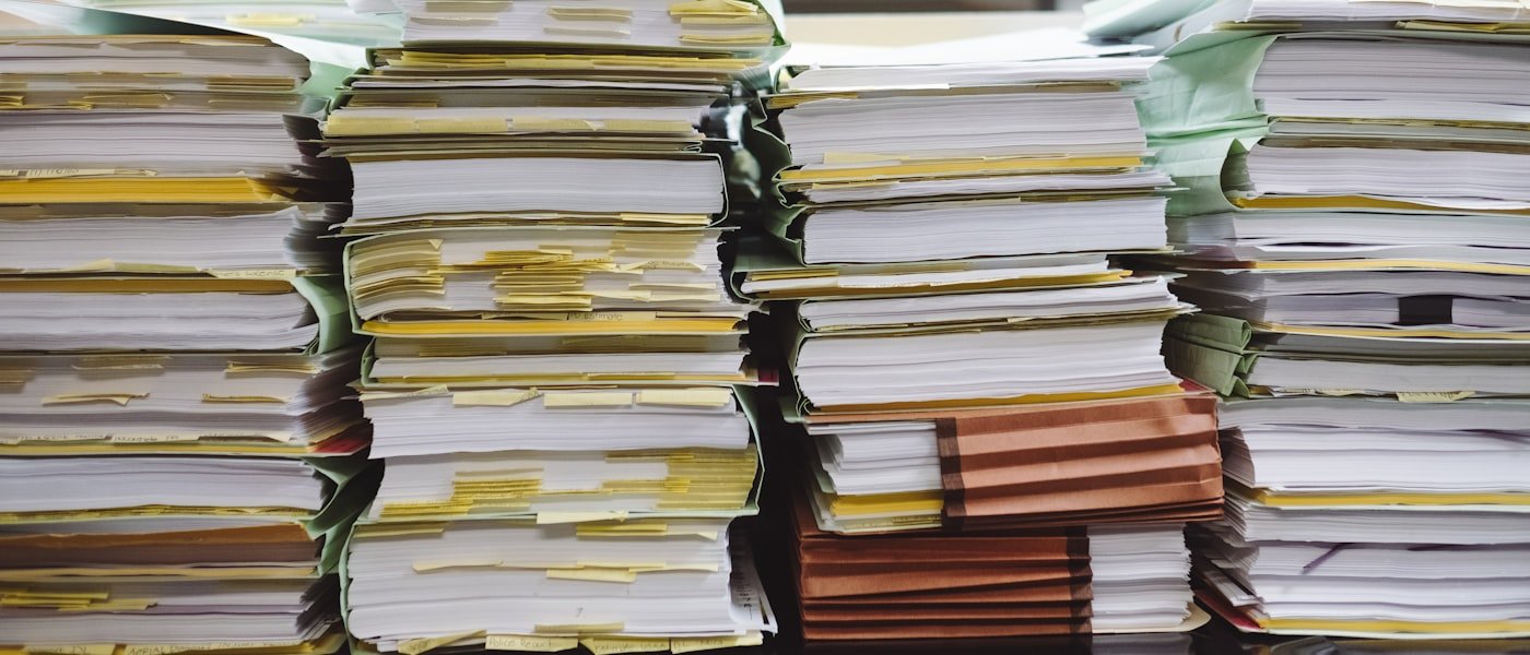 Paperwork and a laptop on a desk mid-process